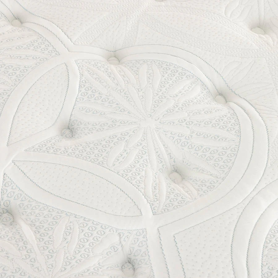 Close-up of a Sleepyhead mattress or cushion with quilted leaf and floral stitched patterns and small round buttons.