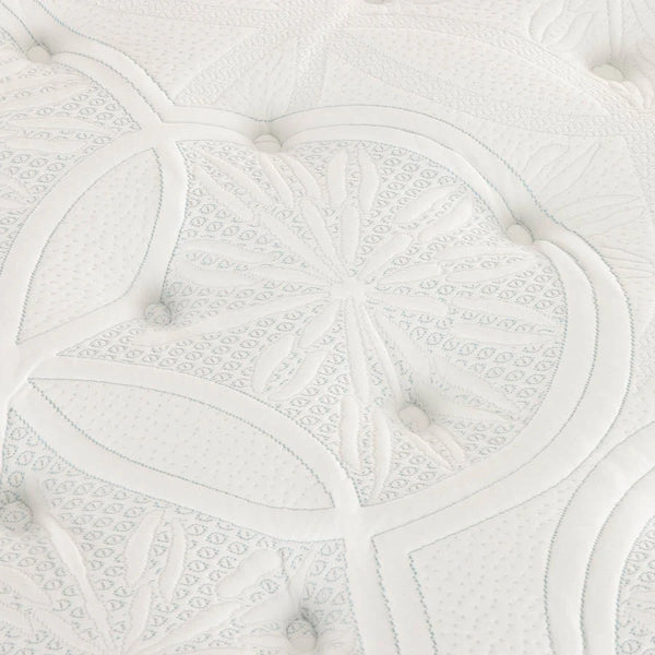 Close-up of a Sleepyhead mattress or cushion with quilted leaf and floral stitched patterns and small round buttons.