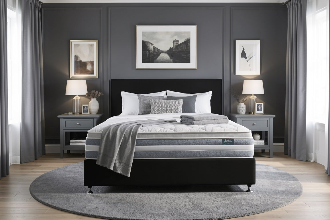 Bedroom with a Sleepyhead mattress, black bed frame and gray bedding, featuring two nightstands with lamps and framed pictures on the wall.