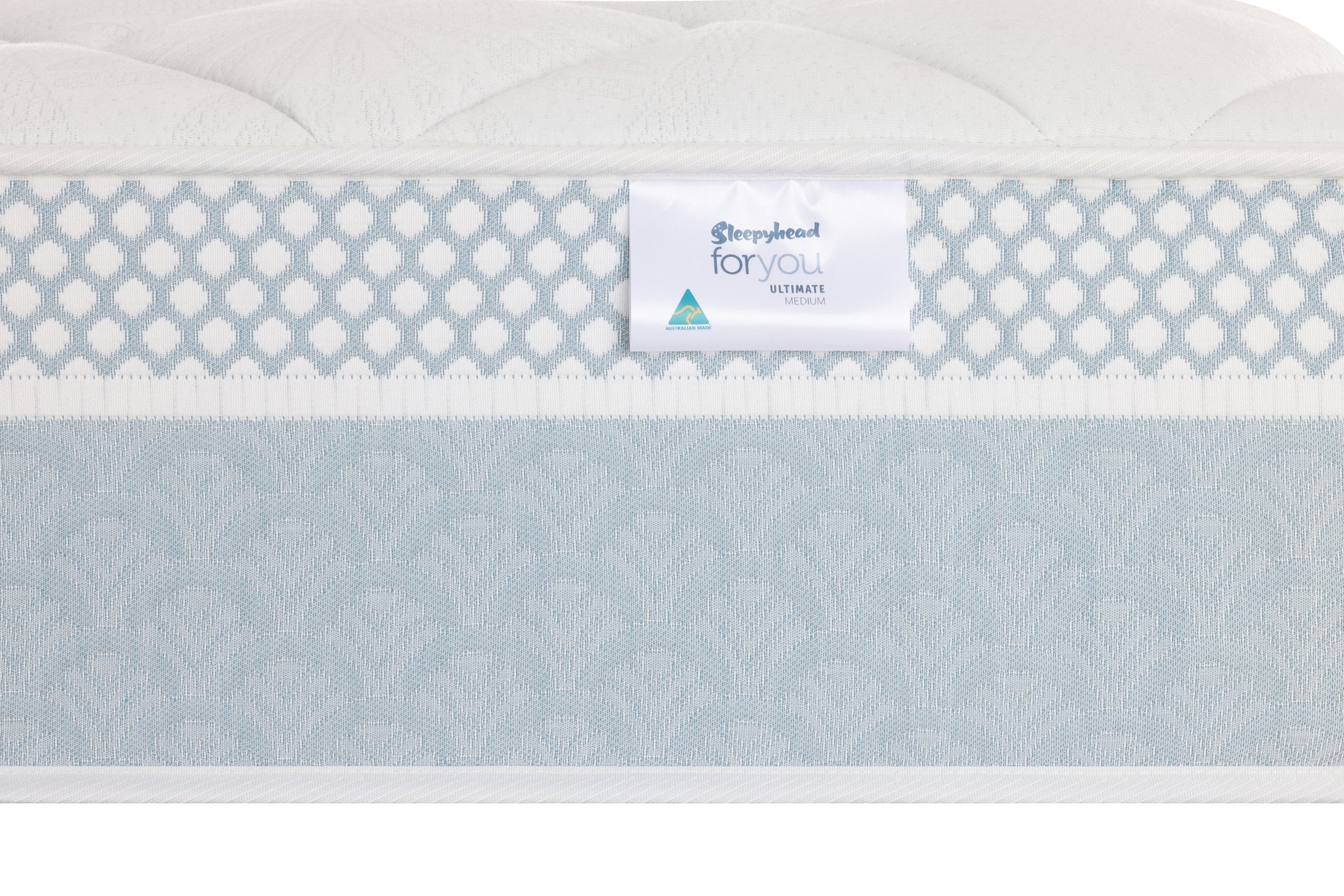 Close-up of a mattress side panel showing a white brand label that reads 'Sleepyhead For You Ultimate' against a light blue and white patterned mattress cover.