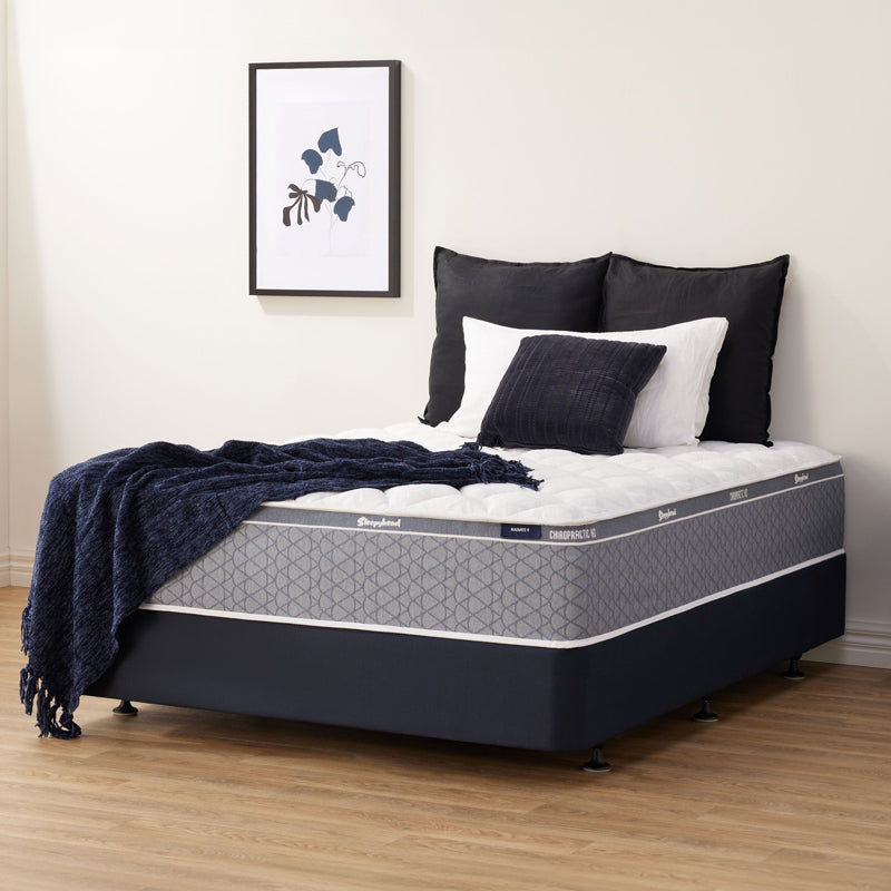 Sleepyhead Chiropractic mattress, pillows, and a blanket in a bedroom setting.