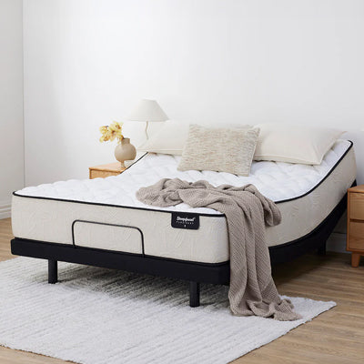 Sleepyhead mattress with a blanket and pillows on a bed in a room setting