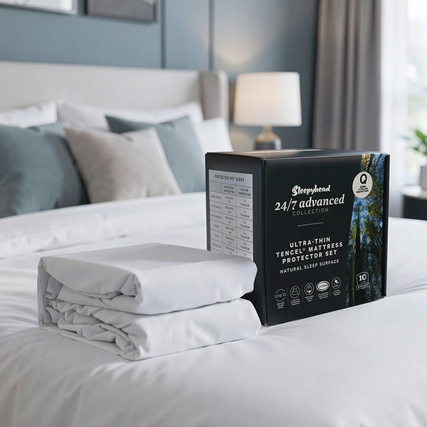 Sleepyhead mattress protector set packaging on a bed in a bedroom setting
