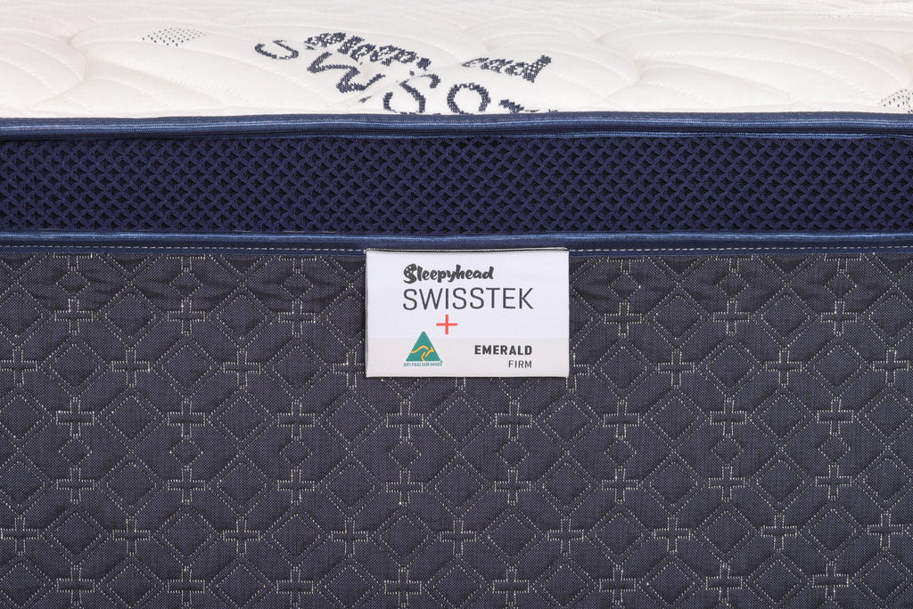 Close-up of a mattress with 'Sleepyhead Swisstek' branding on a white background